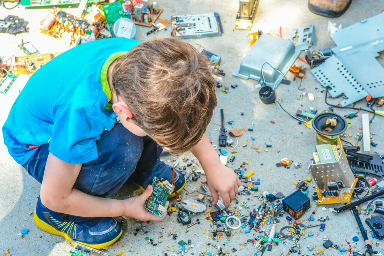 A student building a project from a tray of electronic parts