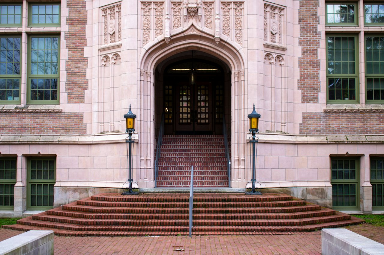 An arched stone entrance at the top of a flight of brick steps